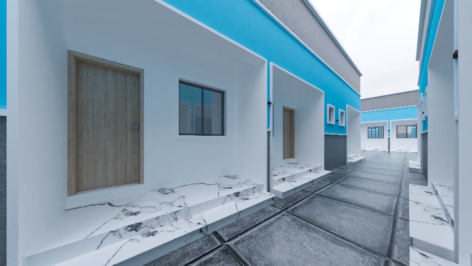 Paved walkway between turquoise lodge units with sheltered entrances