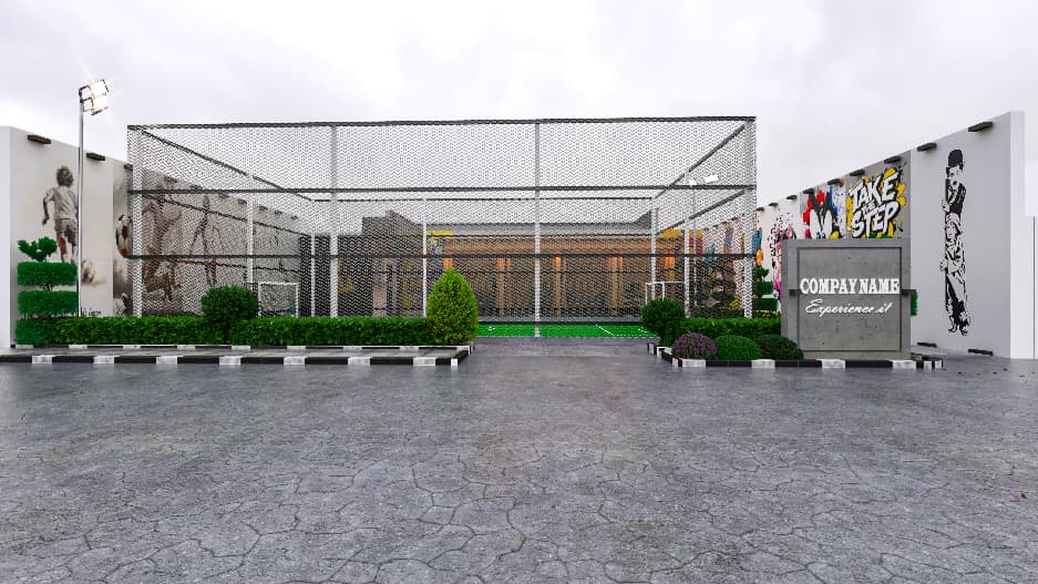 Enclosed football court and landscaped entrance seen from the road